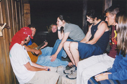 Mike is playing guitar on the porch